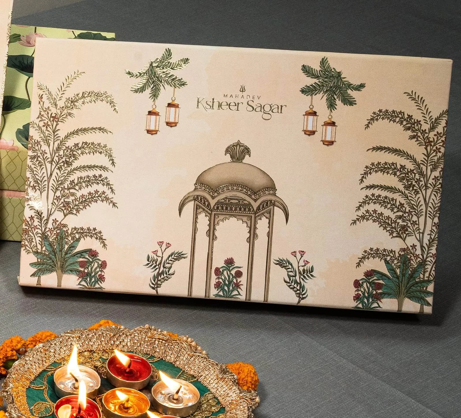 Mahadev Ksheer Sagar mithai box open, showing Gomti Nagar Extension address insert